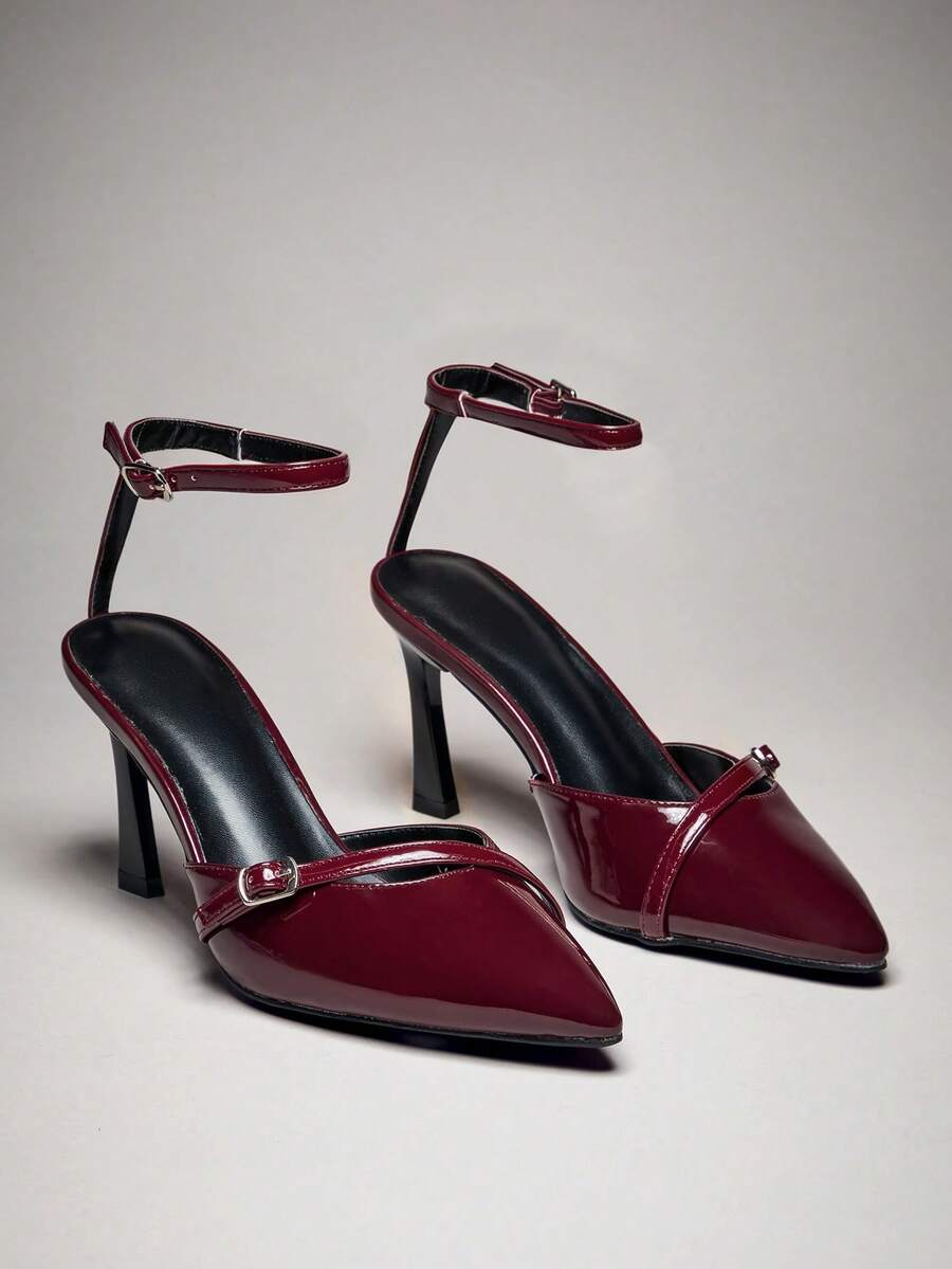 Women's pointed toe stiletto heel slingback pumps in chocolate brown with double metal buckle strap details.
