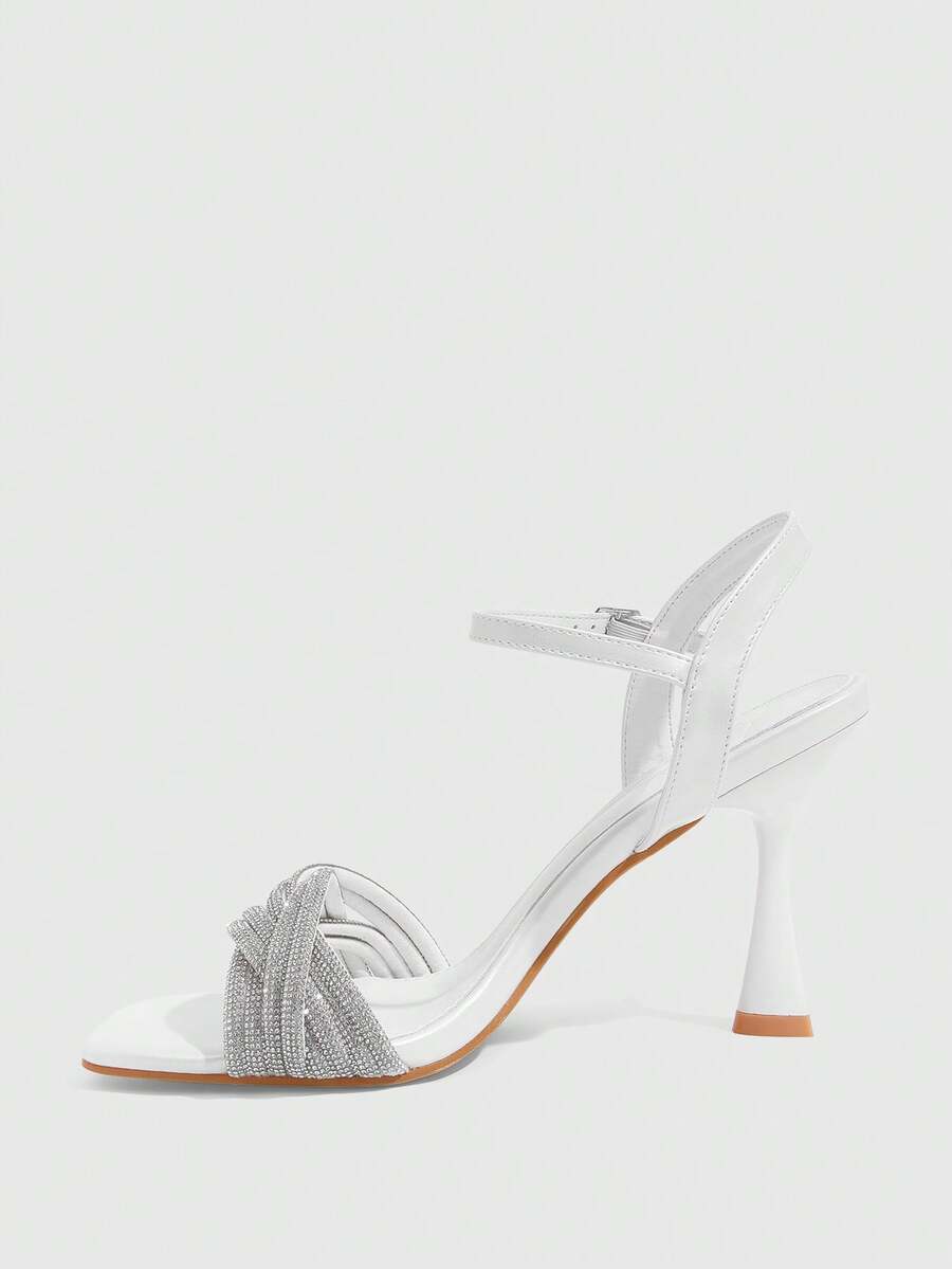 Women's gold open square toe high-heeled sandals featuring a stylish twist strap and stiletto heel.
