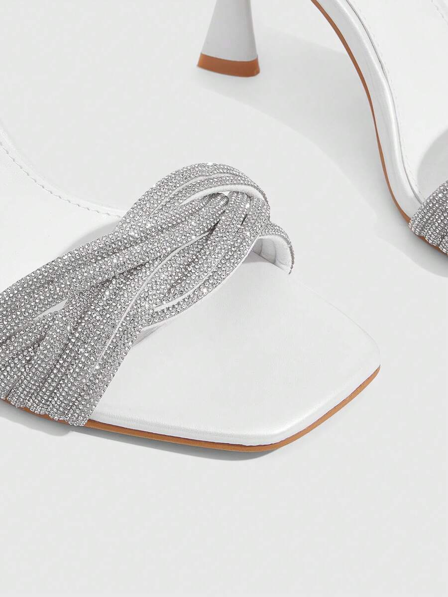 Women's gold open square toe high-heeled sandals featuring a stylish twist strap and stiletto heel.