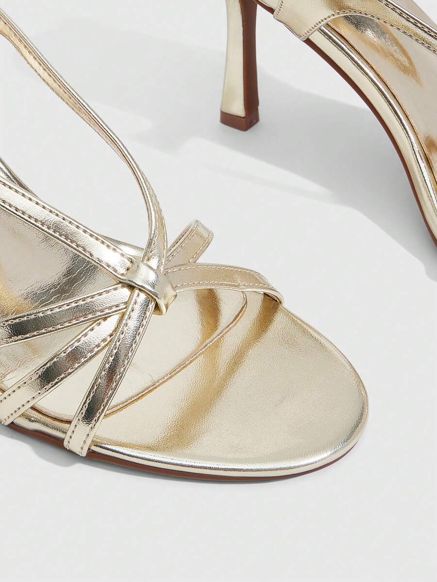 Women's high heel sandals featuring pleated strap detailing, an adjustable ankle strap with buckle closure, round open toe, and slim stiletto heel.