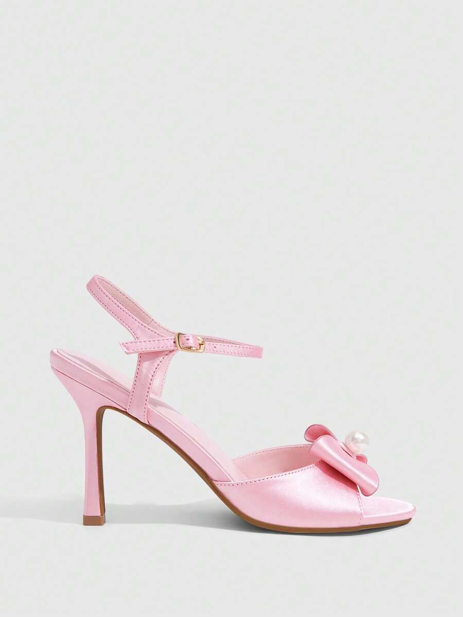 Elegant women's satin high heel sandals with pearl embellishments, stiletto heels, and slingback straps for bridal and wedding wear.
