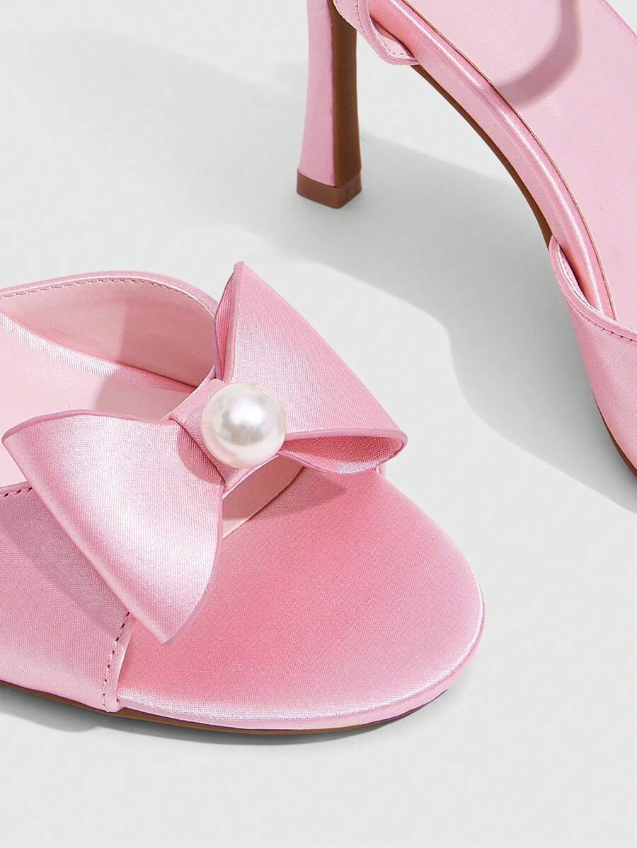 Elegant women's satin high heel sandals with pearl embellishments, stiletto heels, and slingback straps for bridal and wedding wear.