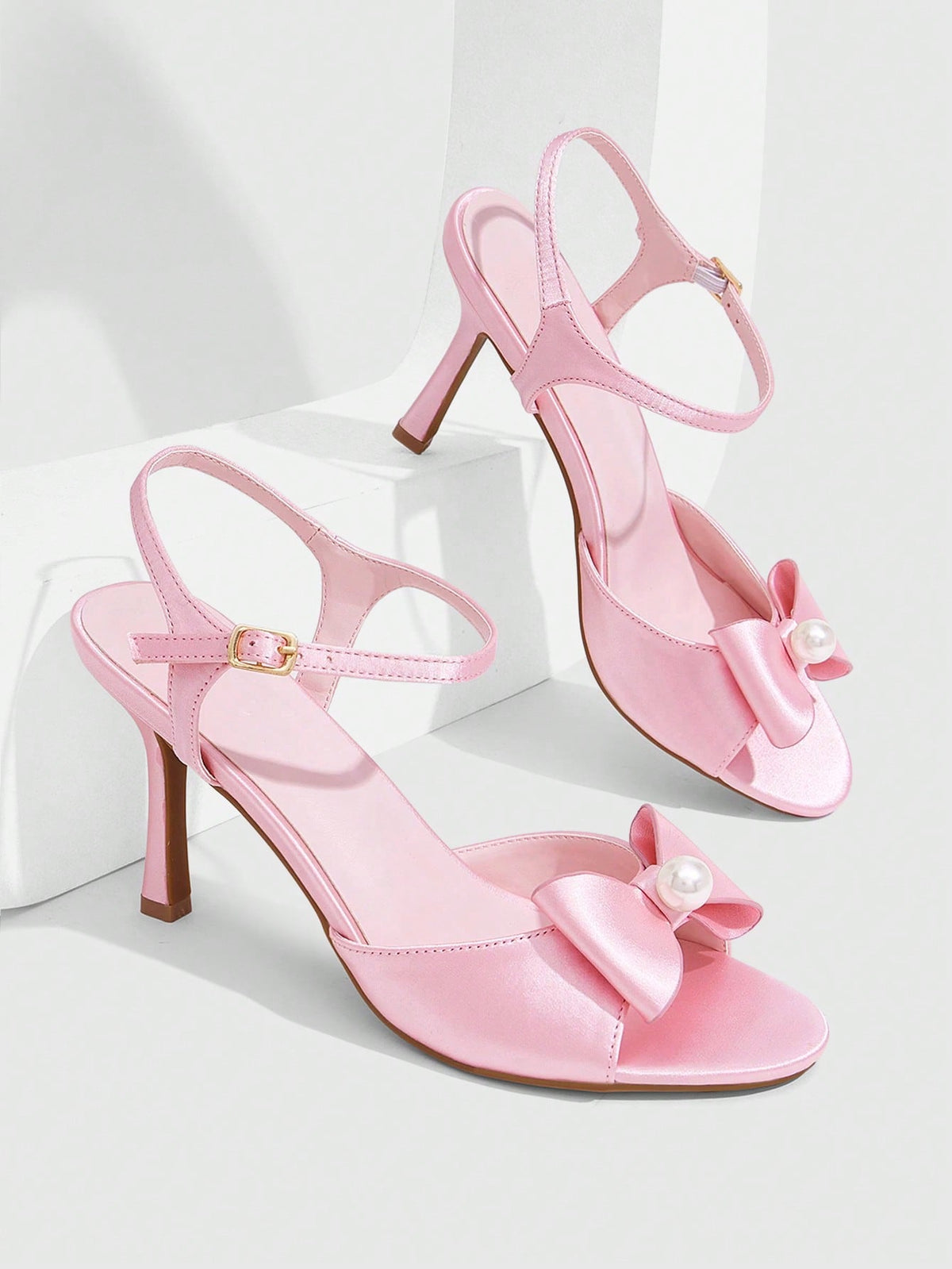 Elegant women's satin high heel sandals with pearl embellishments, stiletto heels, and slingback straps for bridal and wedding wear.