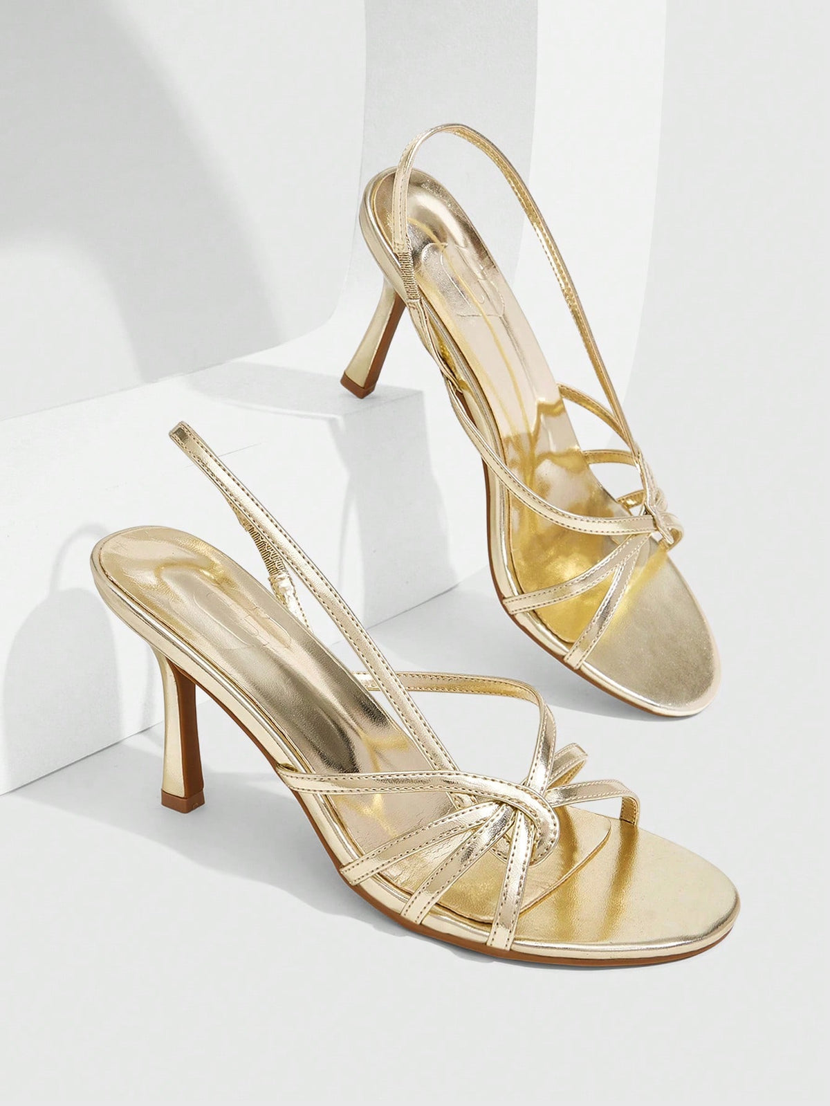Women's high heel sandals featuring pleated strap detailing, an adjustable ankle strap with buckle closure, round open toe, and slim stiletto heel.
