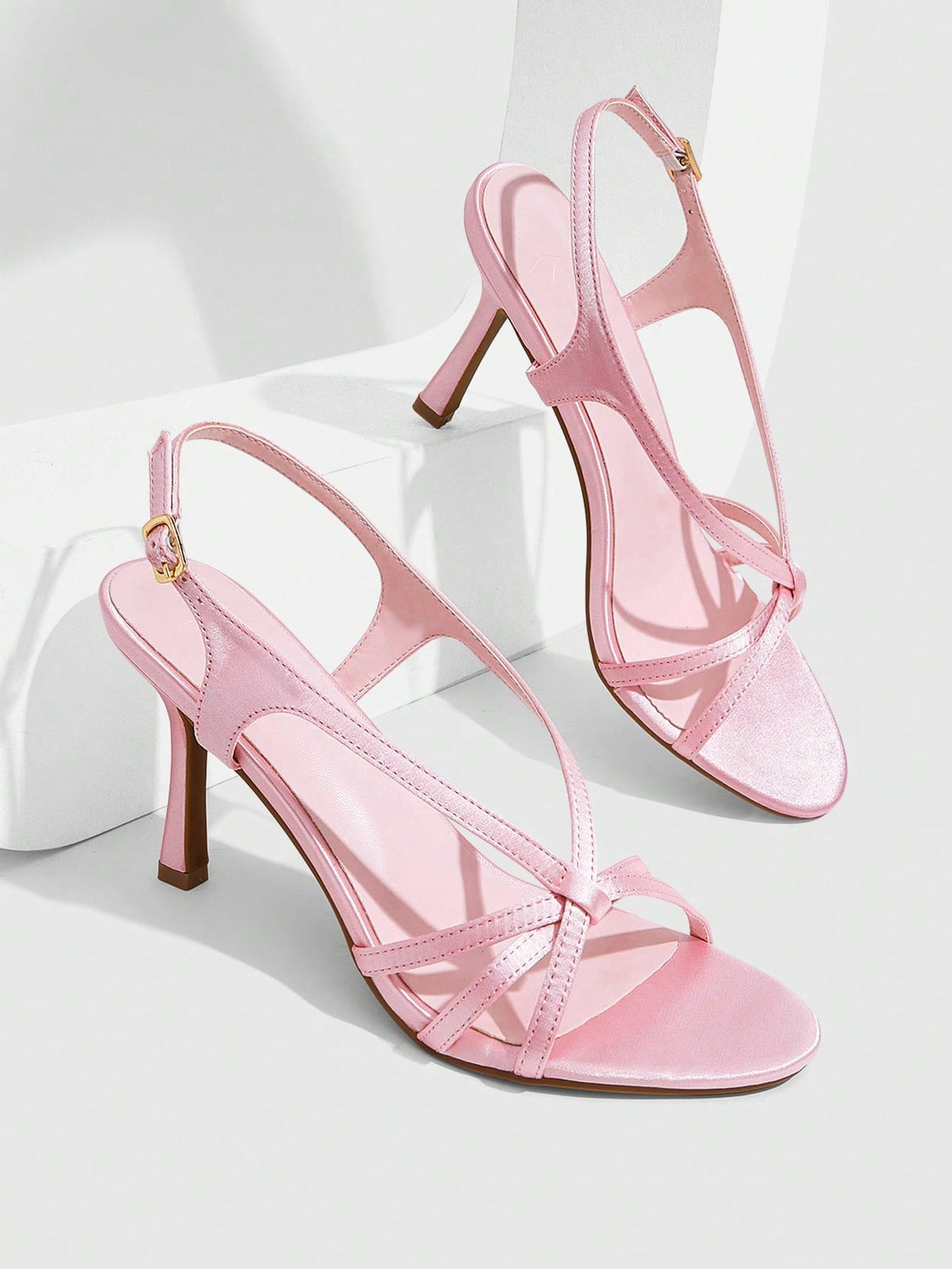 Elegant women's satin high heel sandals with pearl embellishments, stiletto heels, and slingback straps for bridal and wedding wear.