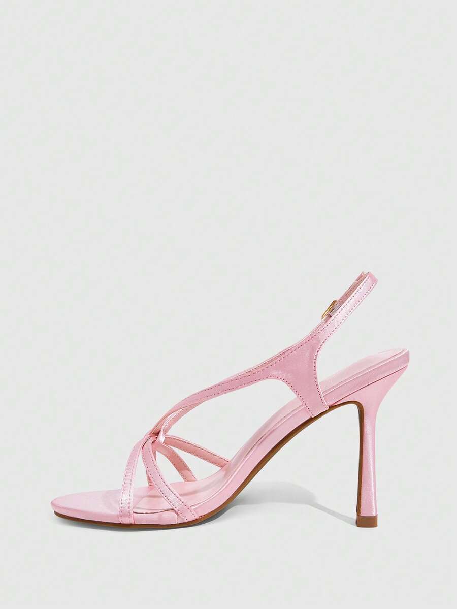 Elegant women's satin high heel sandals with pearl embellishments, stiletto heels, and slingback straps for bridal and wedding wear.
