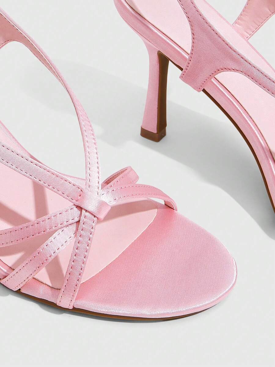 Elegant women's satin high heel sandals with pearl embellishments, stiletto heels, and slingback straps for bridal and wedding wear.