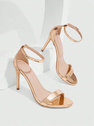 Women's stiletto sandals featuring an ankle strap buckle closure and classic round open toe design.