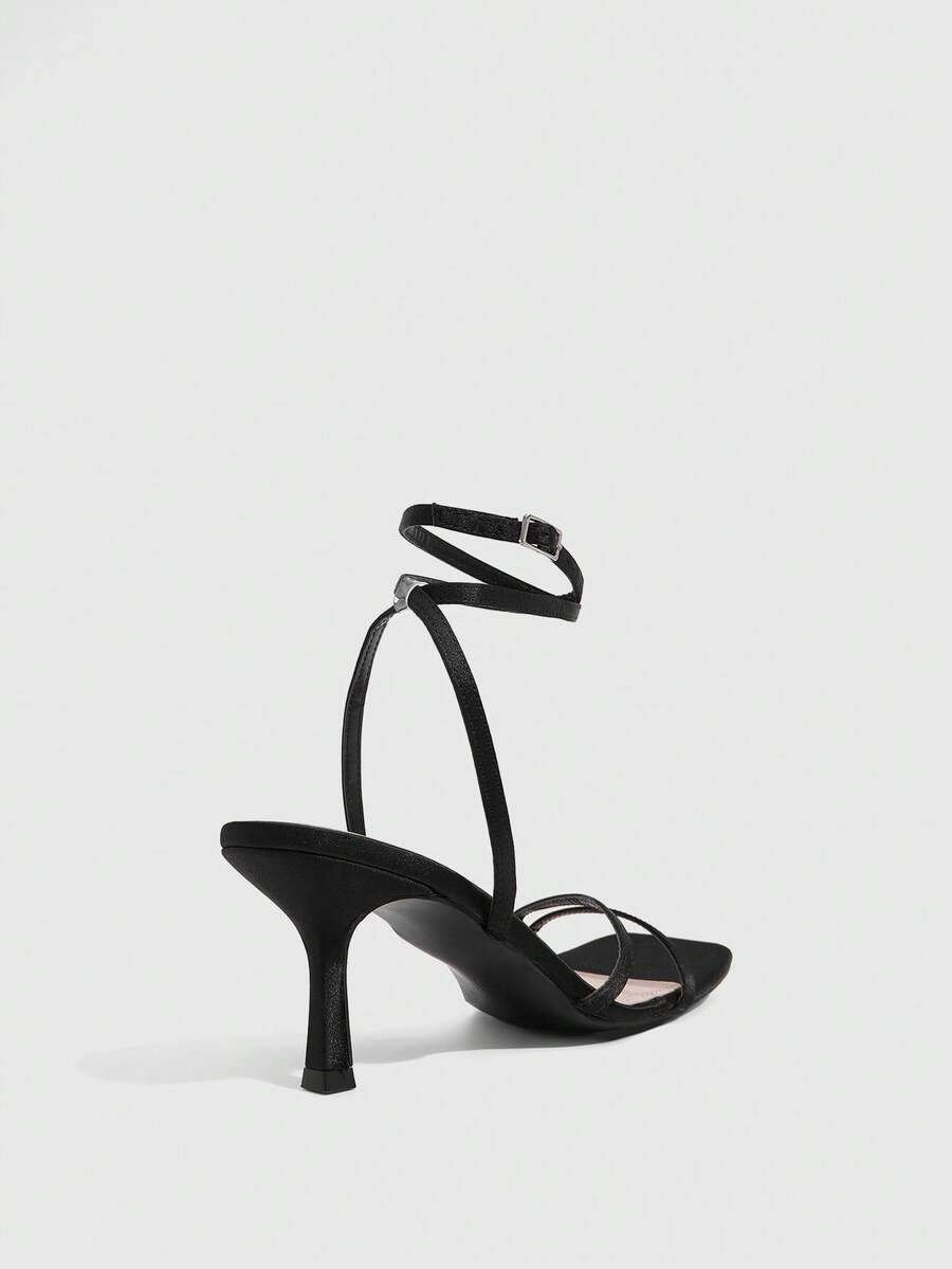 Women's square toe stiletto high heeled sandals with ankle strap buckle in a sleek faux leather finish.