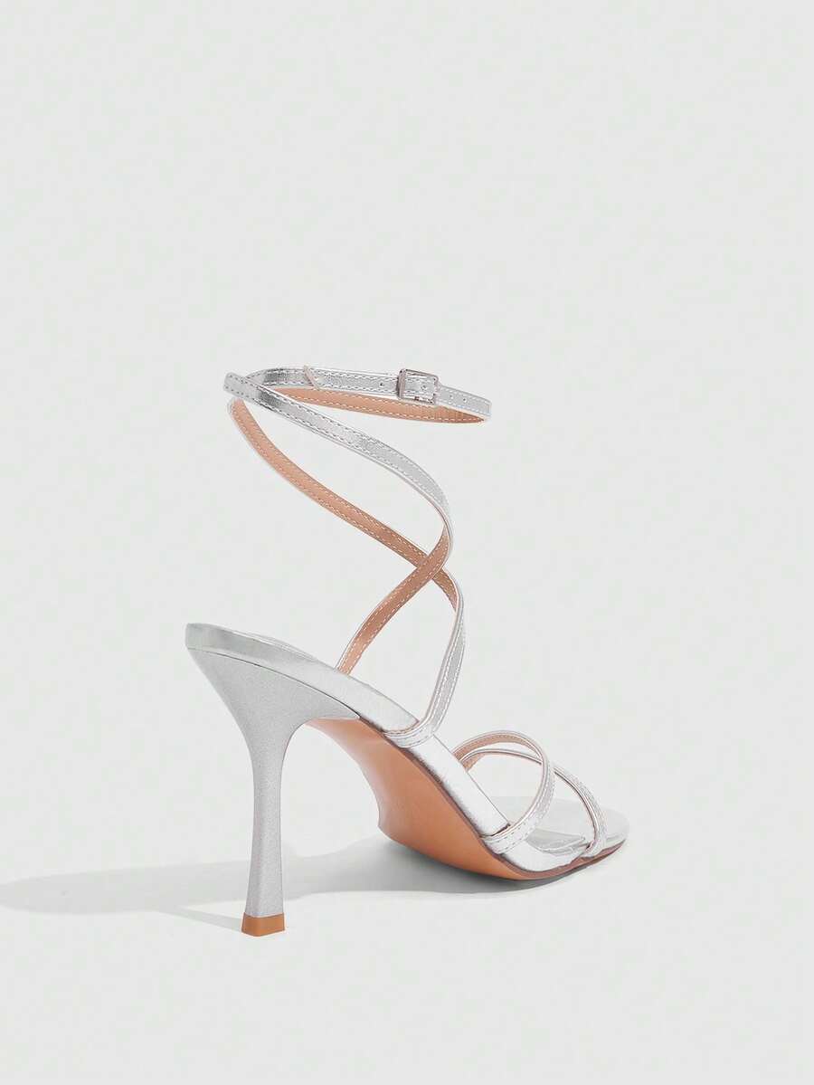 Women's square toe stiletto high heeled sandals with ankle strap buckle in a sleek faux leather finish.