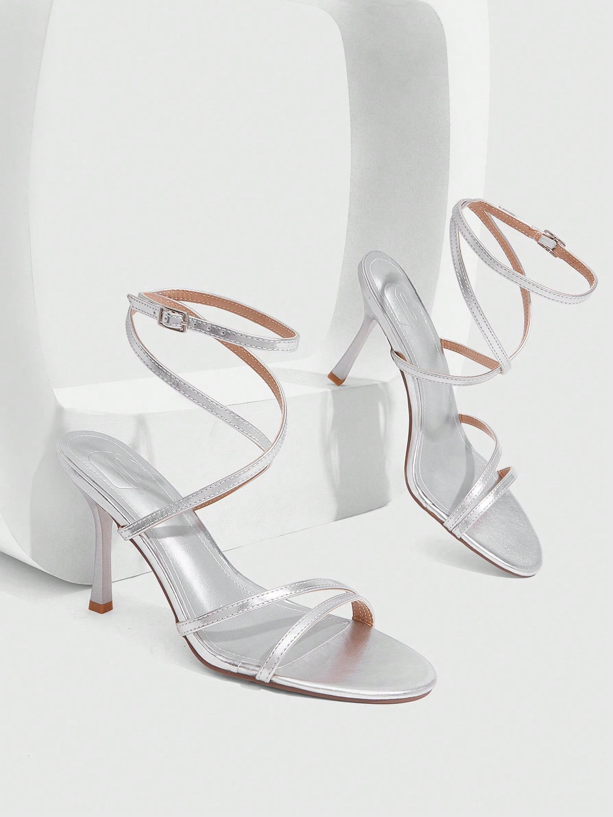 Women's square toe stiletto high heeled sandals with ankle strap buckle in a sleek faux leather finish.