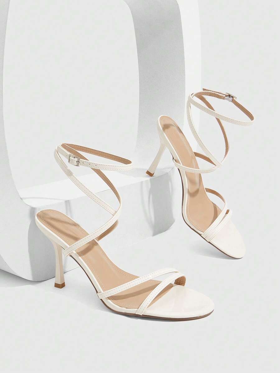 Women's square toe stiletto high heeled sandals with ankle strap buckle in a sleek faux leather finish.