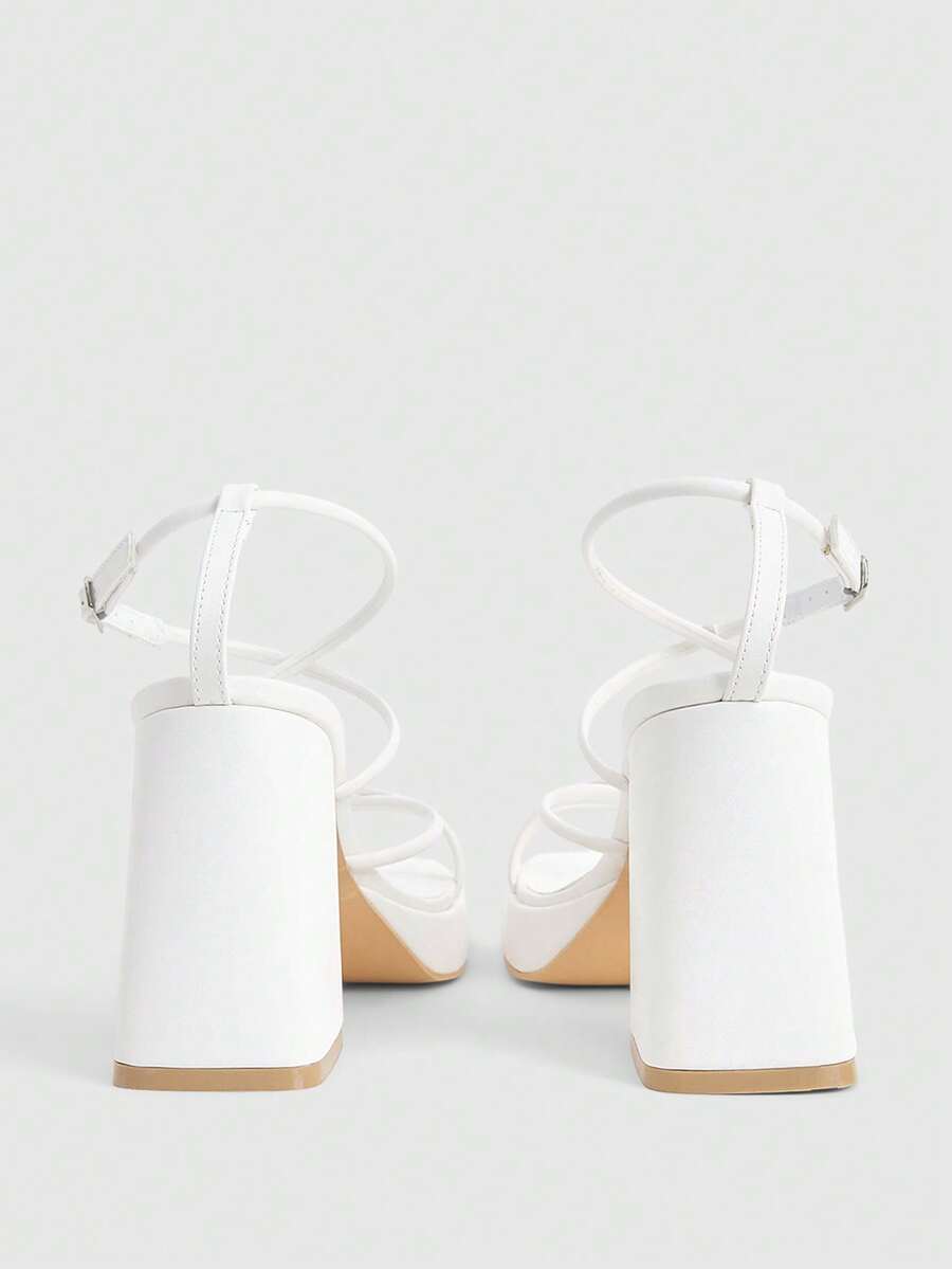 Women's high-heeled sandals with textured pattern, open toe design, chunky heel, and adjustable ankle buckle strap.