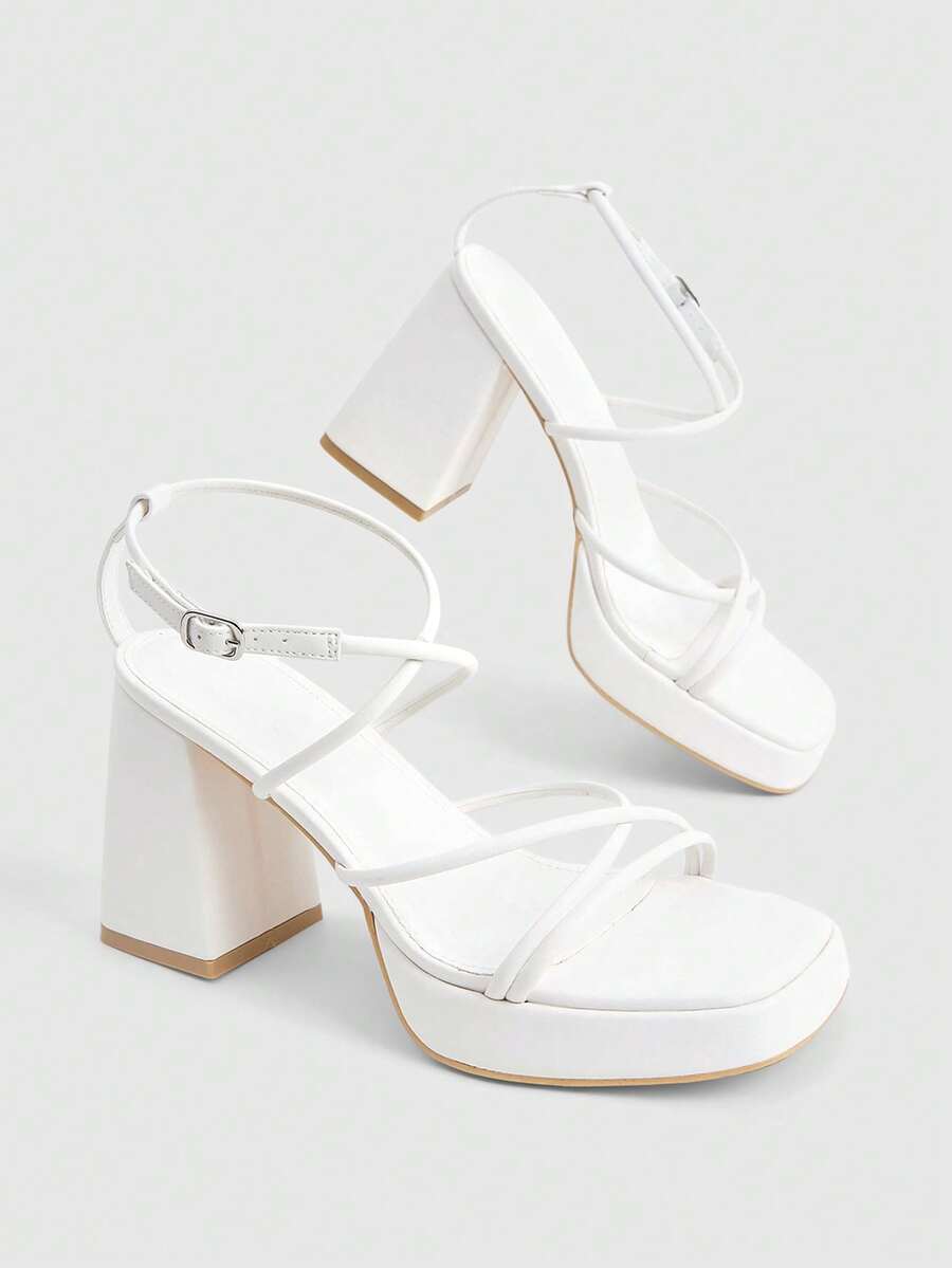 Women's high-heeled sandals with textured pattern, open toe design, chunky heel, and adjustable ankle buckle strap.