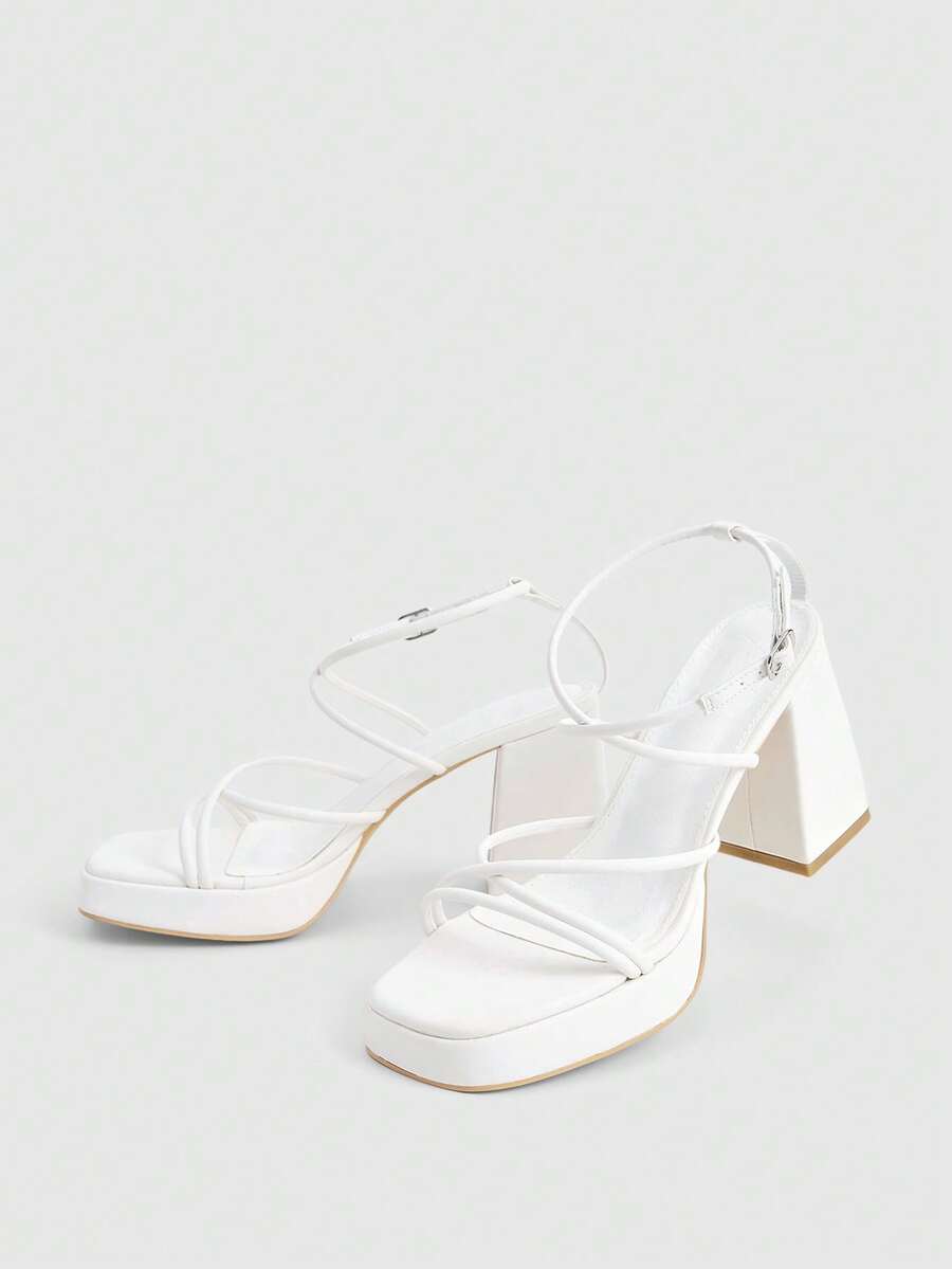 Women's high-heeled sandals with textured pattern, open toe design, chunky heel, and adjustable ankle buckle strap.