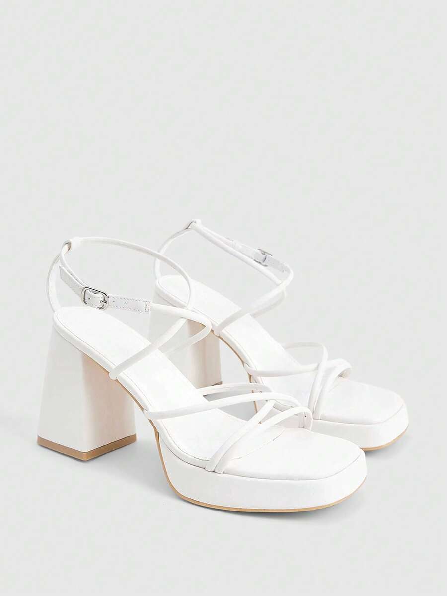Women's high-heeled sandals with textured pattern, open toe design, chunky heel, and adjustable ankle buckle strap.