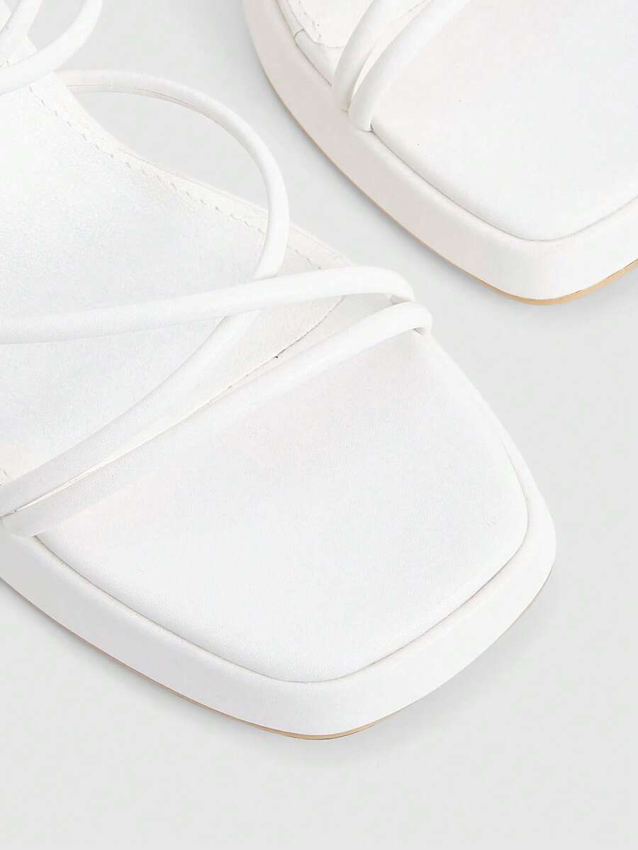 Women's high-heeled sandals with textured pattern, open toe design, chunky heel, and adjustable ankle buckle strap.