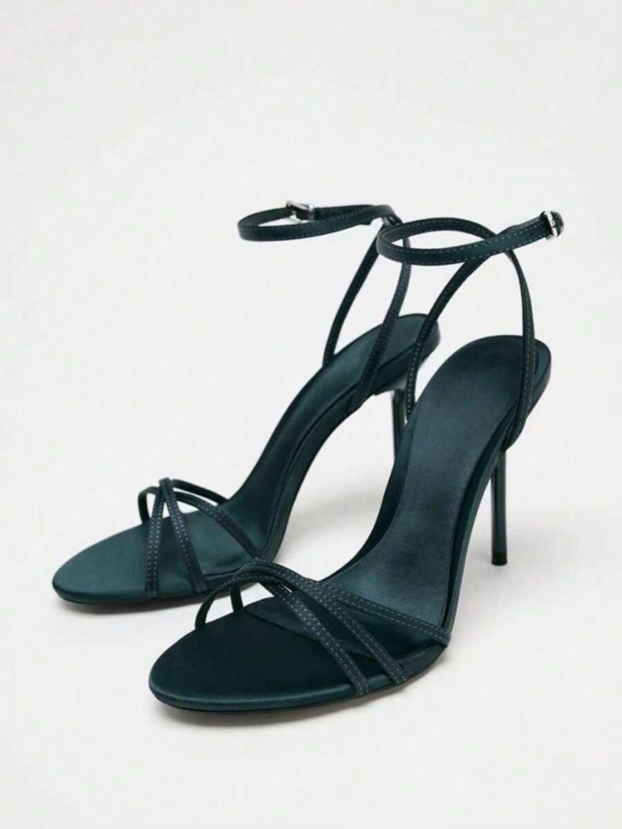 Women's open toe stiletto high heel sandals featuring metallic knot decor and an adjustable ankle buckle strap.