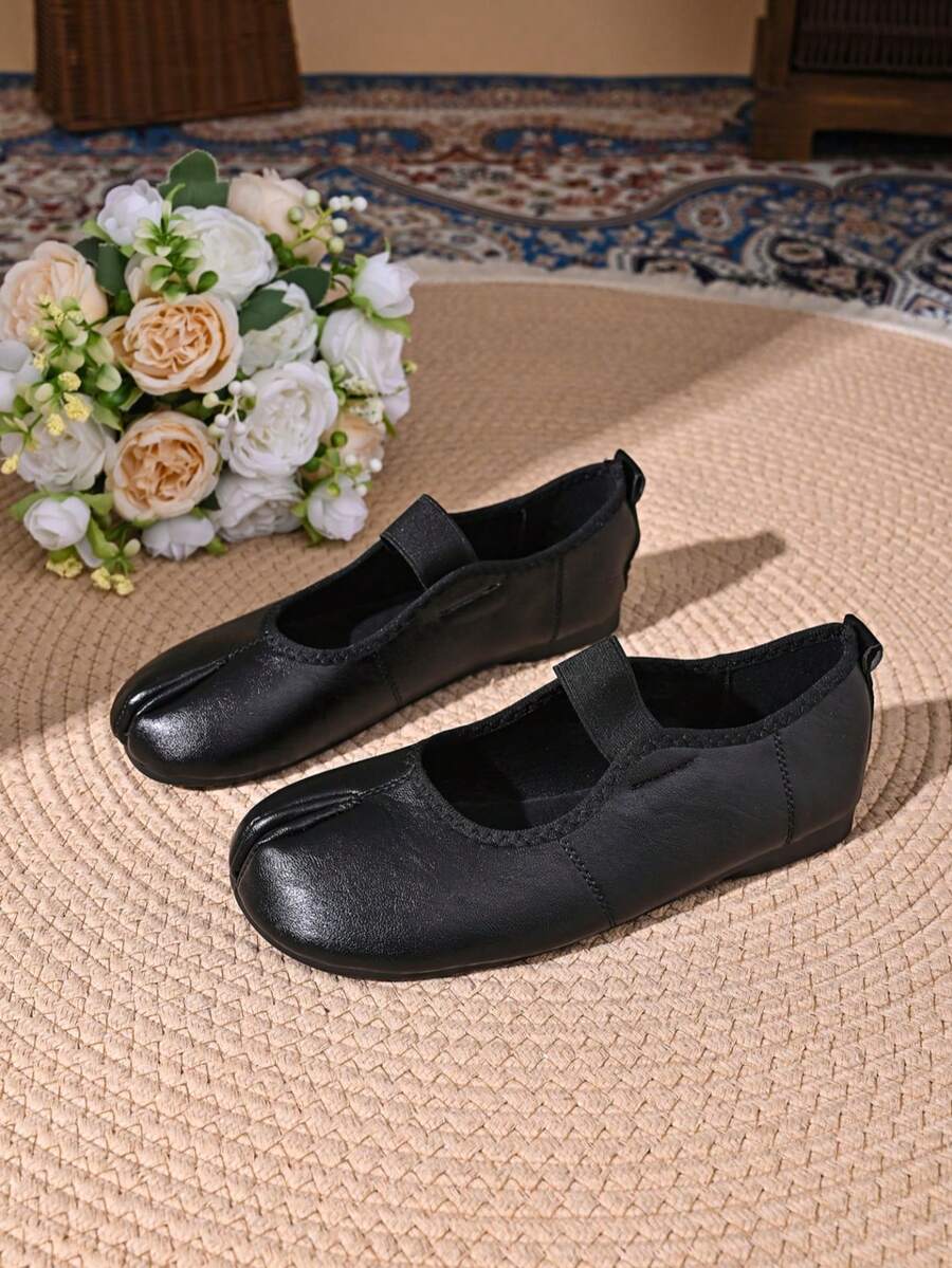 Women's white split-toe slip-on flat shoes with braided accent and rubber sole