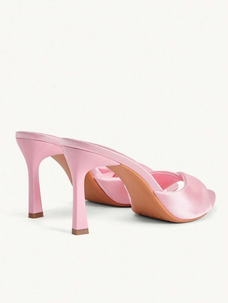 Women's peep toe high-heeled stiletto sandals with slingback strap in light metallic finish.
