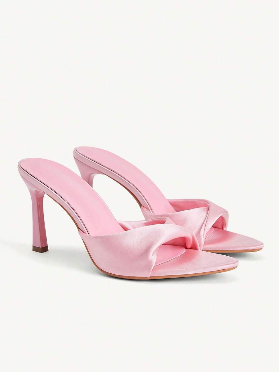 Women's peep toe high-heeled stiletto sandals with slingback strap in light metallic finish.