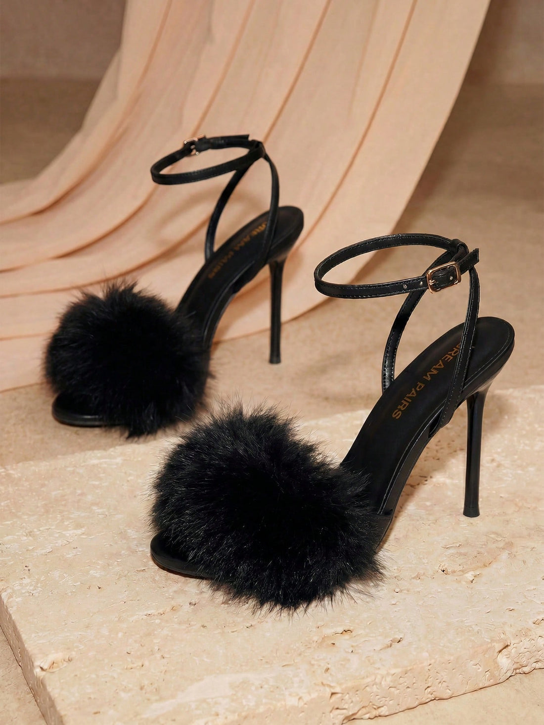 Women's open toe stiletto heeled sandals with fluffy feather detail and adjustable buckle ankle strap.
