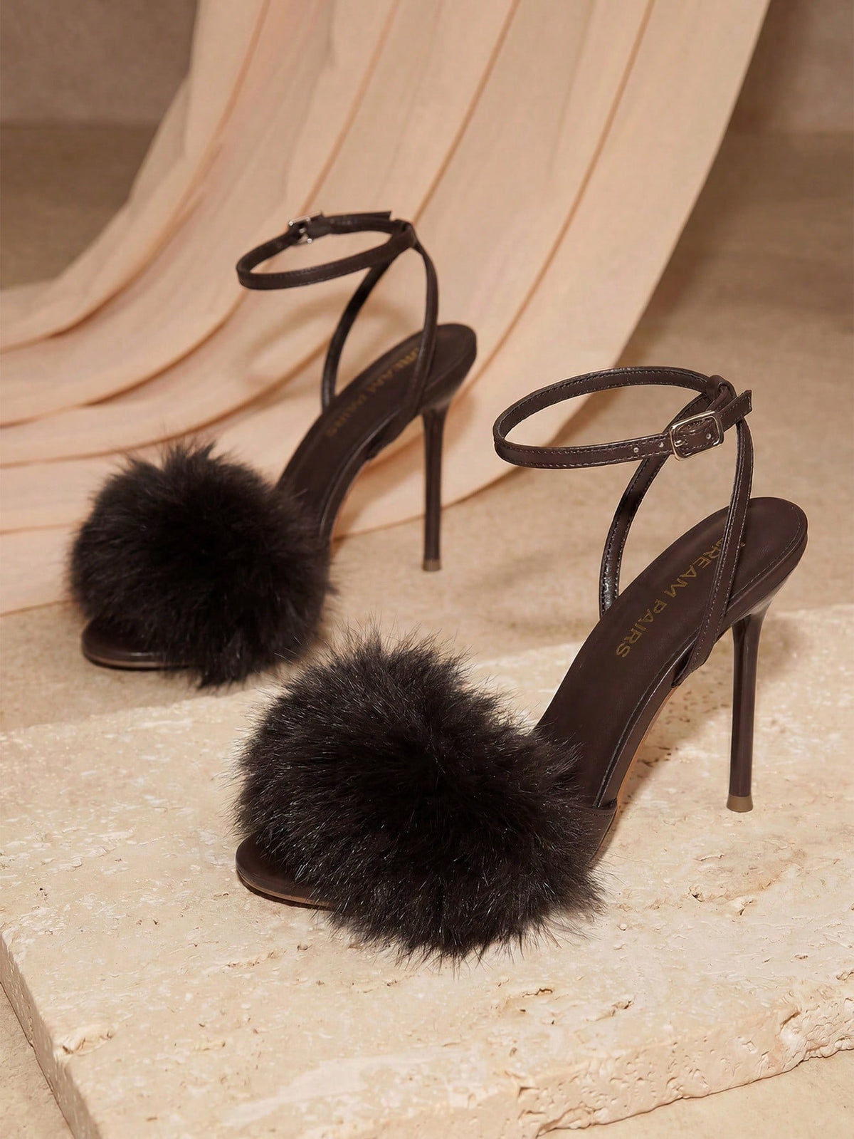 Women's open toe stiletto heeled sandals with fluffy feather detail and adjustable buckle ankle strap.
