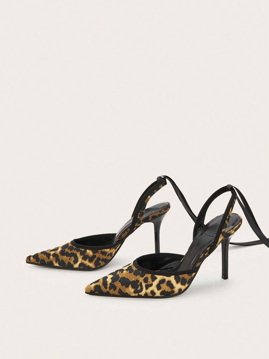 Burgundy satin pointed toe stiletto high heel pumps with a backless design and delicate bow accent.