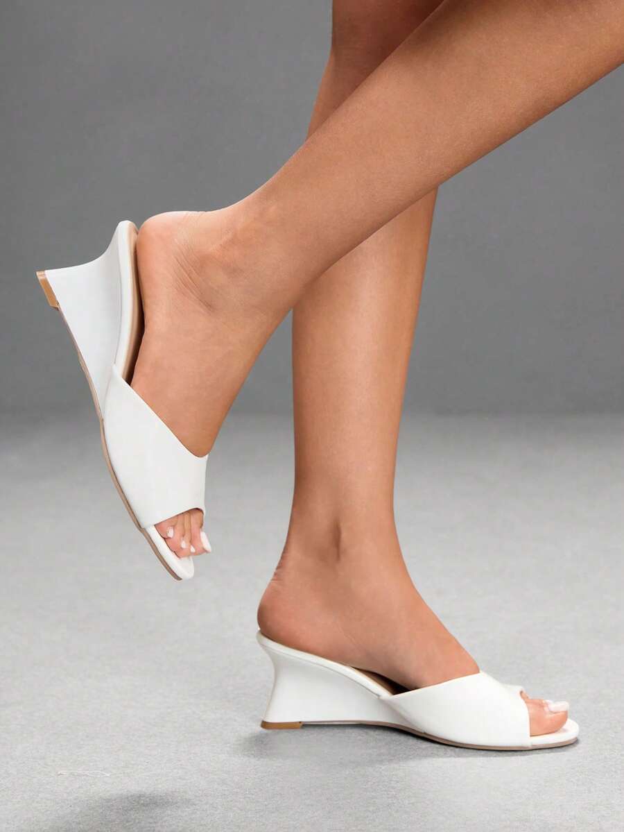 Women's open-toed wedge sandals featuring a smooth PU leather upper, supportive mid wedge heel, and durable rubber sole.
