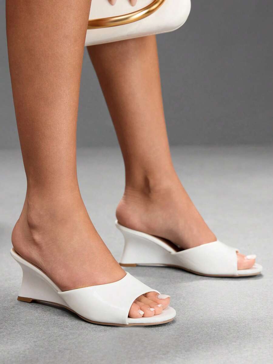 Women's open-toed wedge sandals featuring a smooth PU leather upper, supportive mid wedge heel, and durable rubber sole.