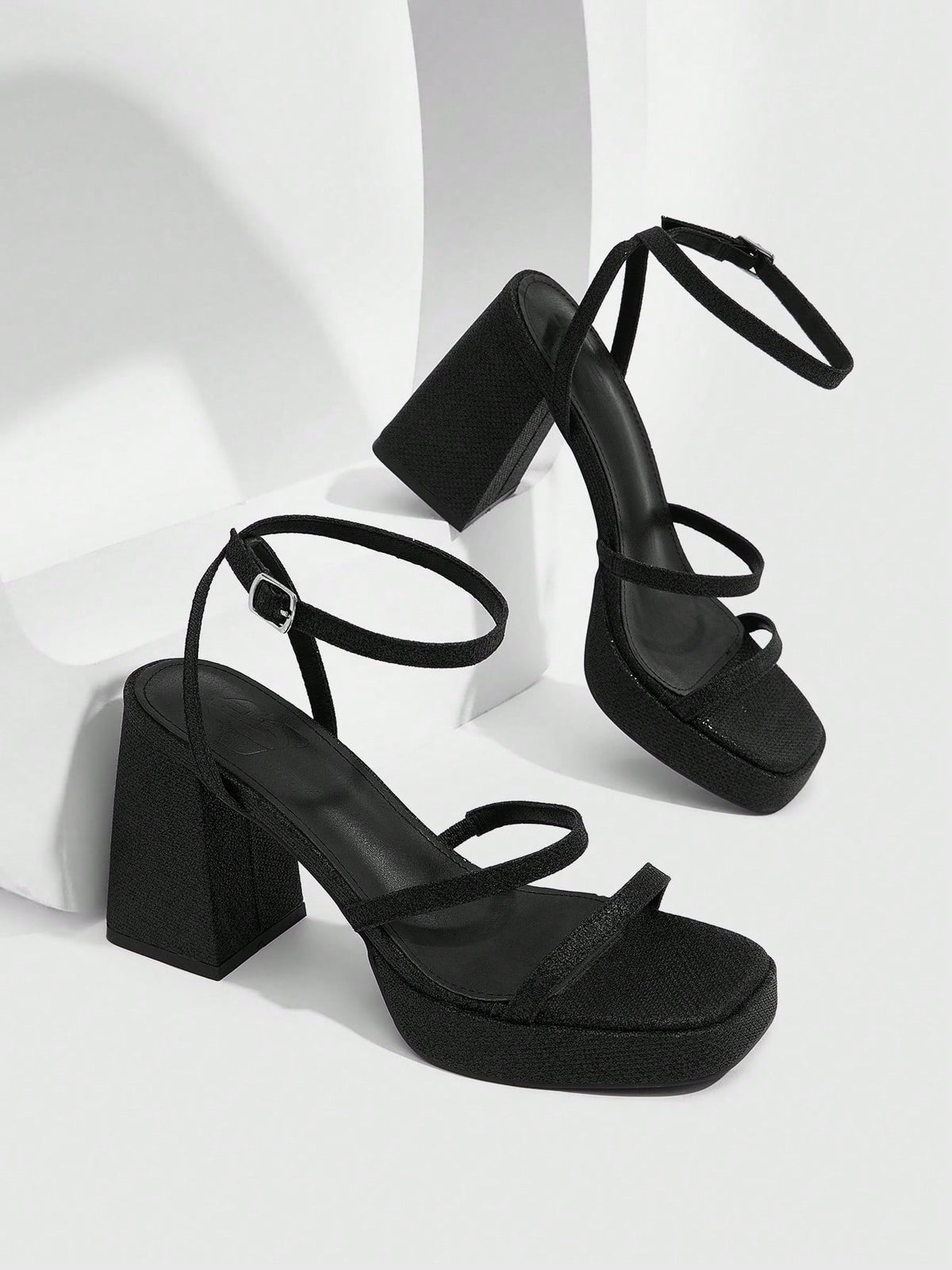 Women's high-heeled sandals with textured pattern, open toe design, chunky heel, and adjustable ankle buckle strap.