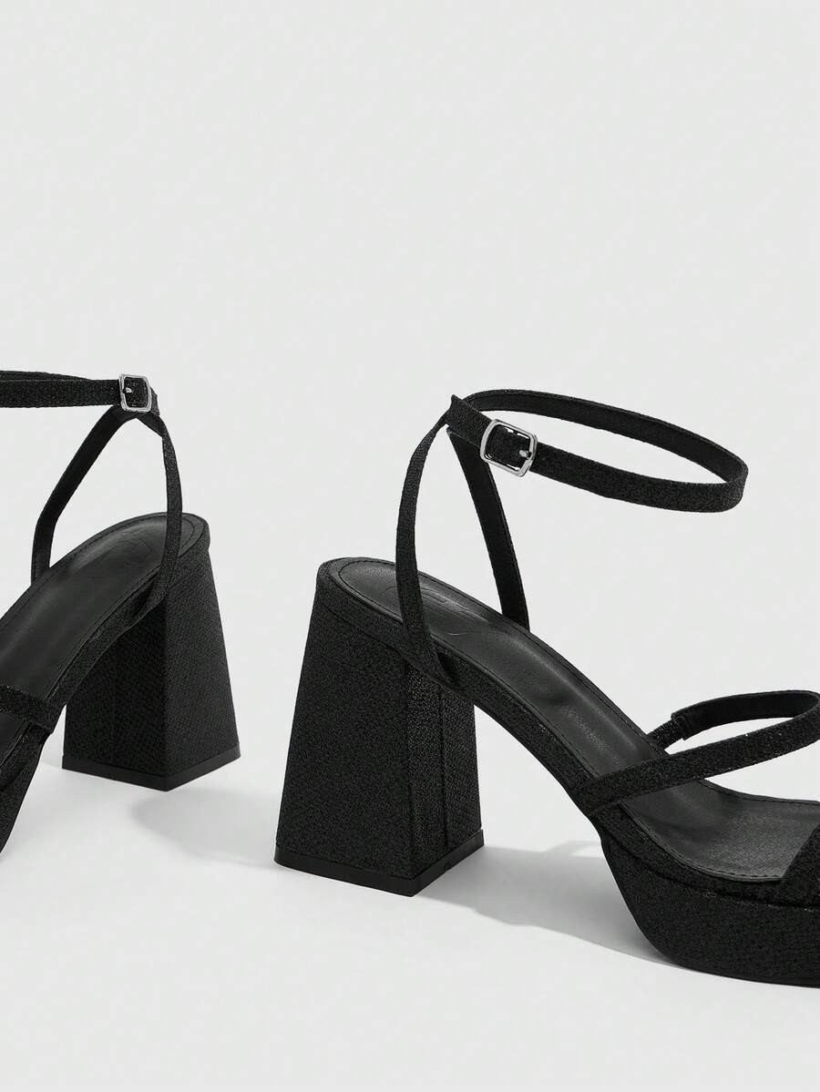 Women's high-heeled sandals with textured pattern, open toe design, chunky heel, and adjustable ankle buckle strap.