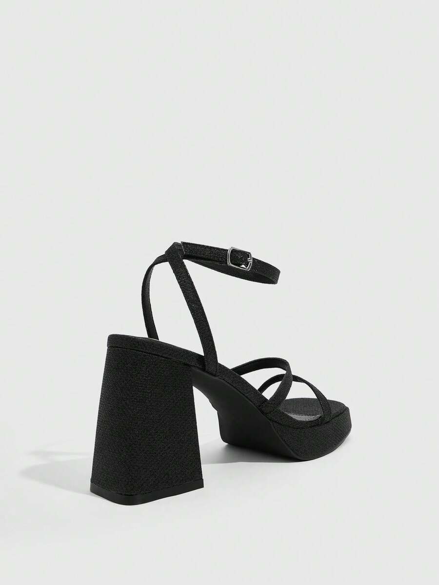 Women's high-heeled sandals with textured pattern, open toe design, chunky heel, and adjustable ankle buckle strap.