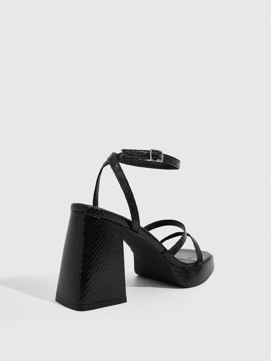 Women's high-heeled sandals with textured pattern, open toe design, chunky heel, and adjustable ankle buckle strap.