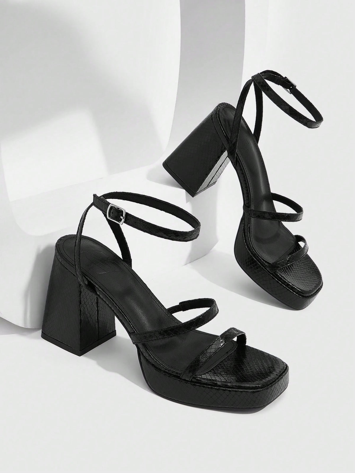 Women's high-heeled sandals with textured pattern, open toe design, chunky heel, and adjustable ankle buckle strap.
