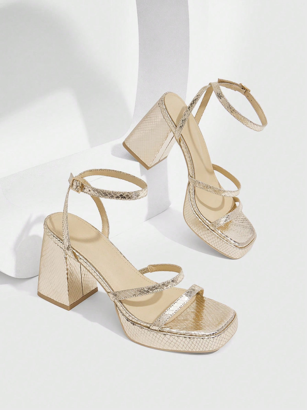 Women's high-heeled sandals with textured pattern, open toe design, chunky heel, and adjustable ankle buckle strap.