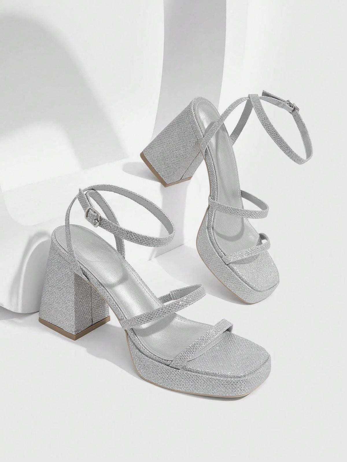 Women's high-heeled sandals with textured pattern, open toe design, chunky heel, and adjustable ankle buckle strap.