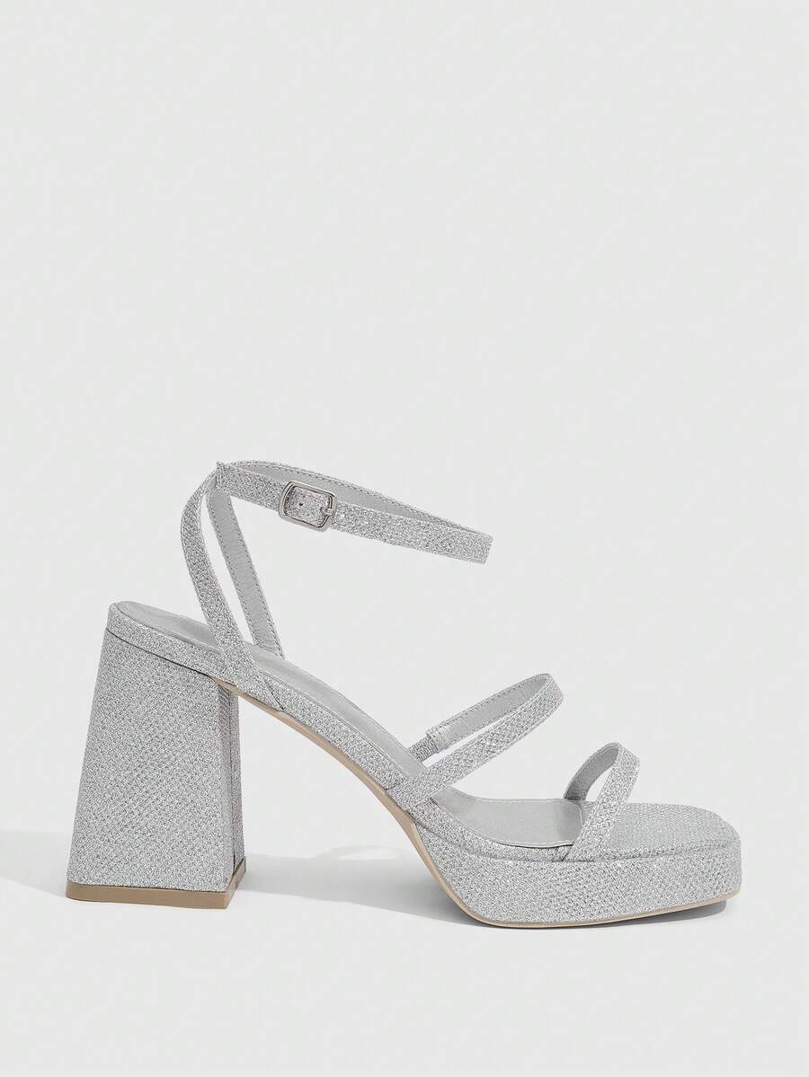 Women's high-heeled sandals with textured pattern, open toe design, chunky heel, and adjustable ankle buckle strap.