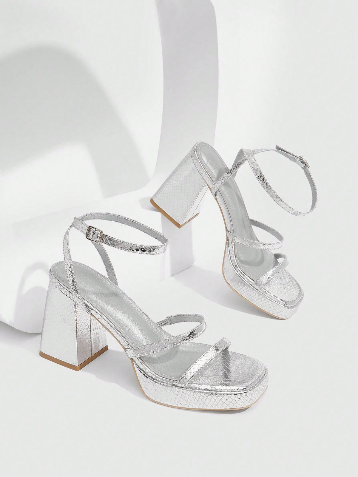 Women's high-heeled sandals with textured pattern, open toe design, chunky heel, and adjustable ankle buckle strap.