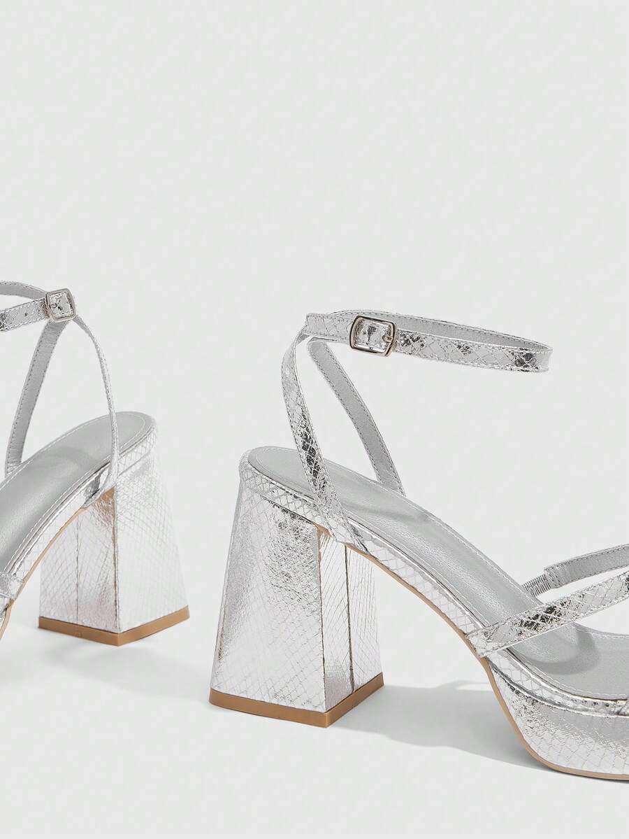 Women's high-heeled sandals with textured pattern, open toe design, chunky heel, and adjustable ankle buckle strap.