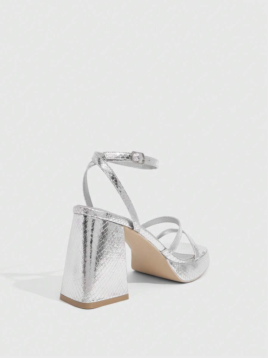 Women's high-heeled sandals with textured pattern, open toe design, chunky heel, and adjustable ankle buckle strap.