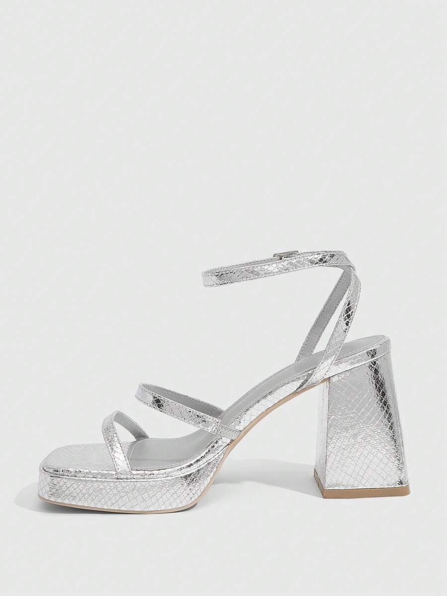 Women's high-heeled sandals with textured pattern, open toe design, chunky heel, and adjustable ankle buckle strap.