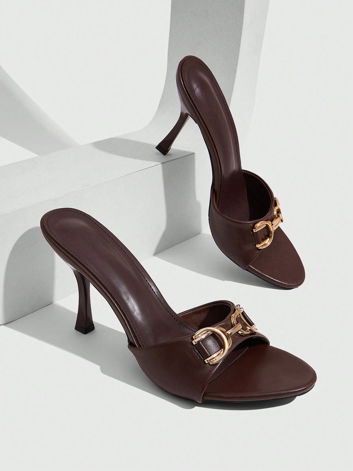 Women's open square toe slender high heel sandals with slingback strap and metal buckle detailing.