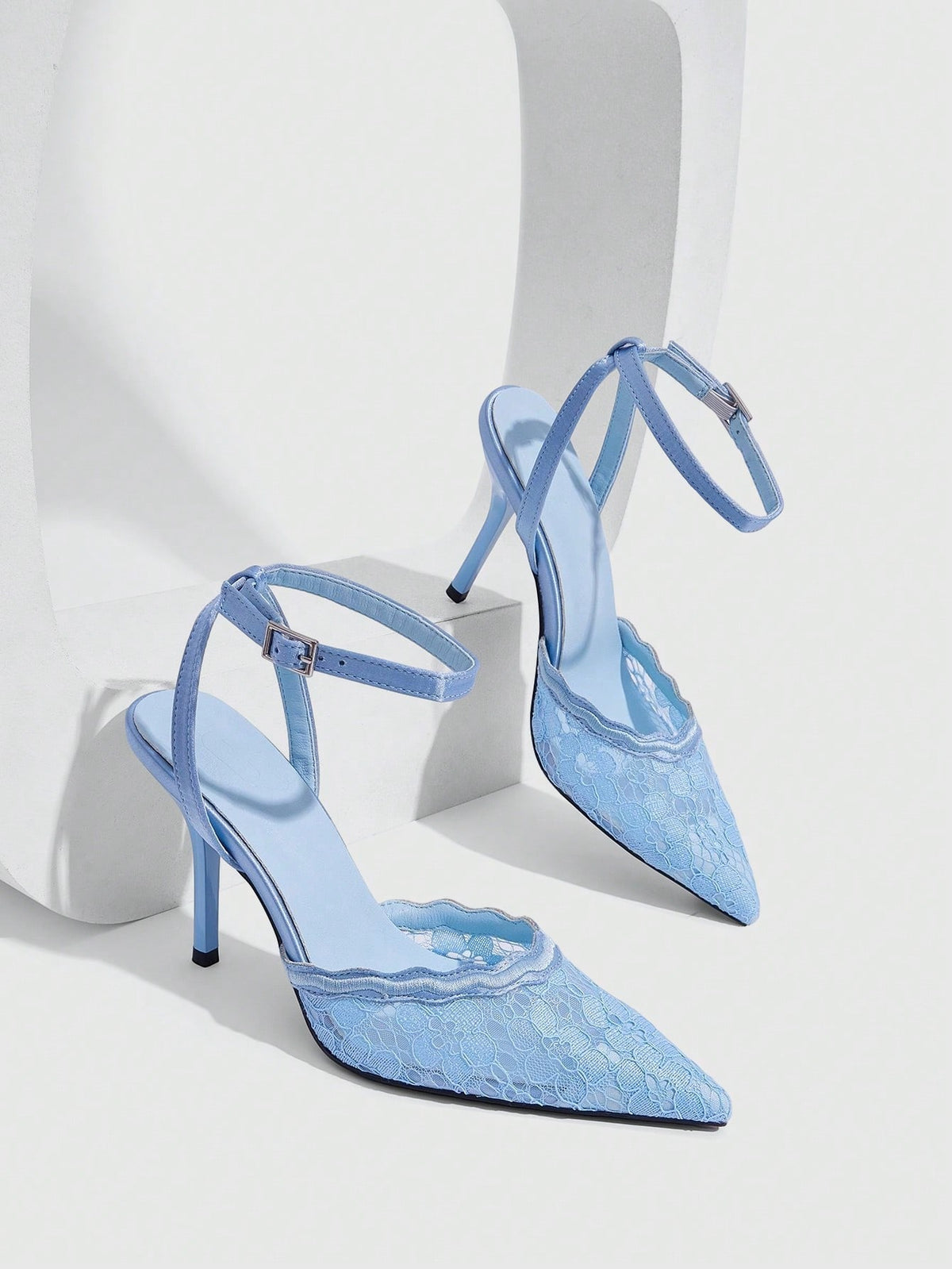Women's stiletto high heel shoes featuring an elegant buckle detail and ankle strap slingback design.