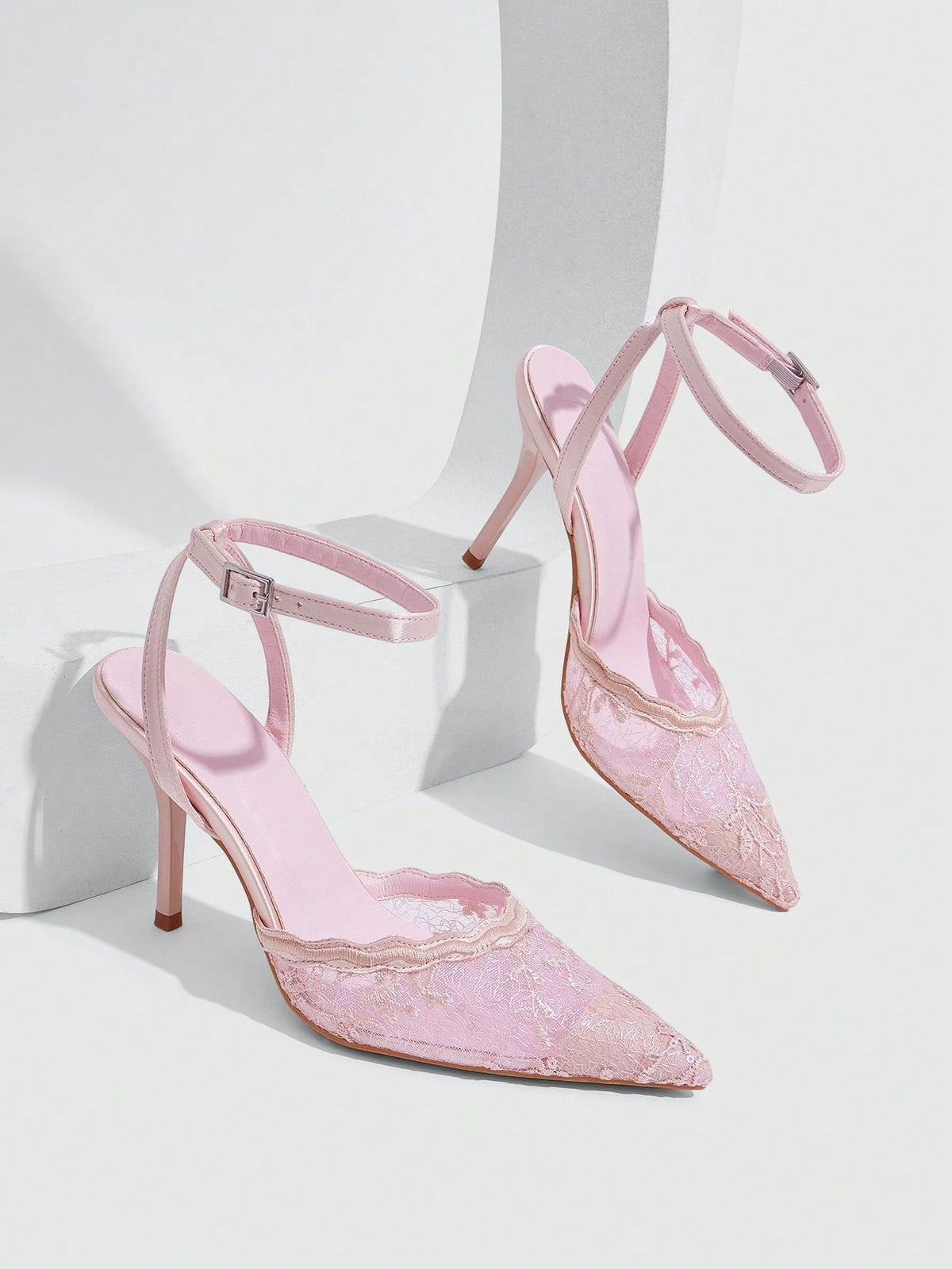 Women's stiletto high heel shoes featuring an elegant buckle detail and ankle strap slingback design.