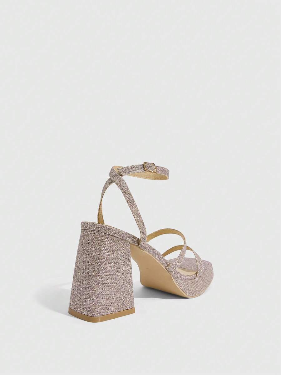 Women's high-heeled sandals with textured pattern, open toe design, chunky heel, and adjustable ankle buckle strap.