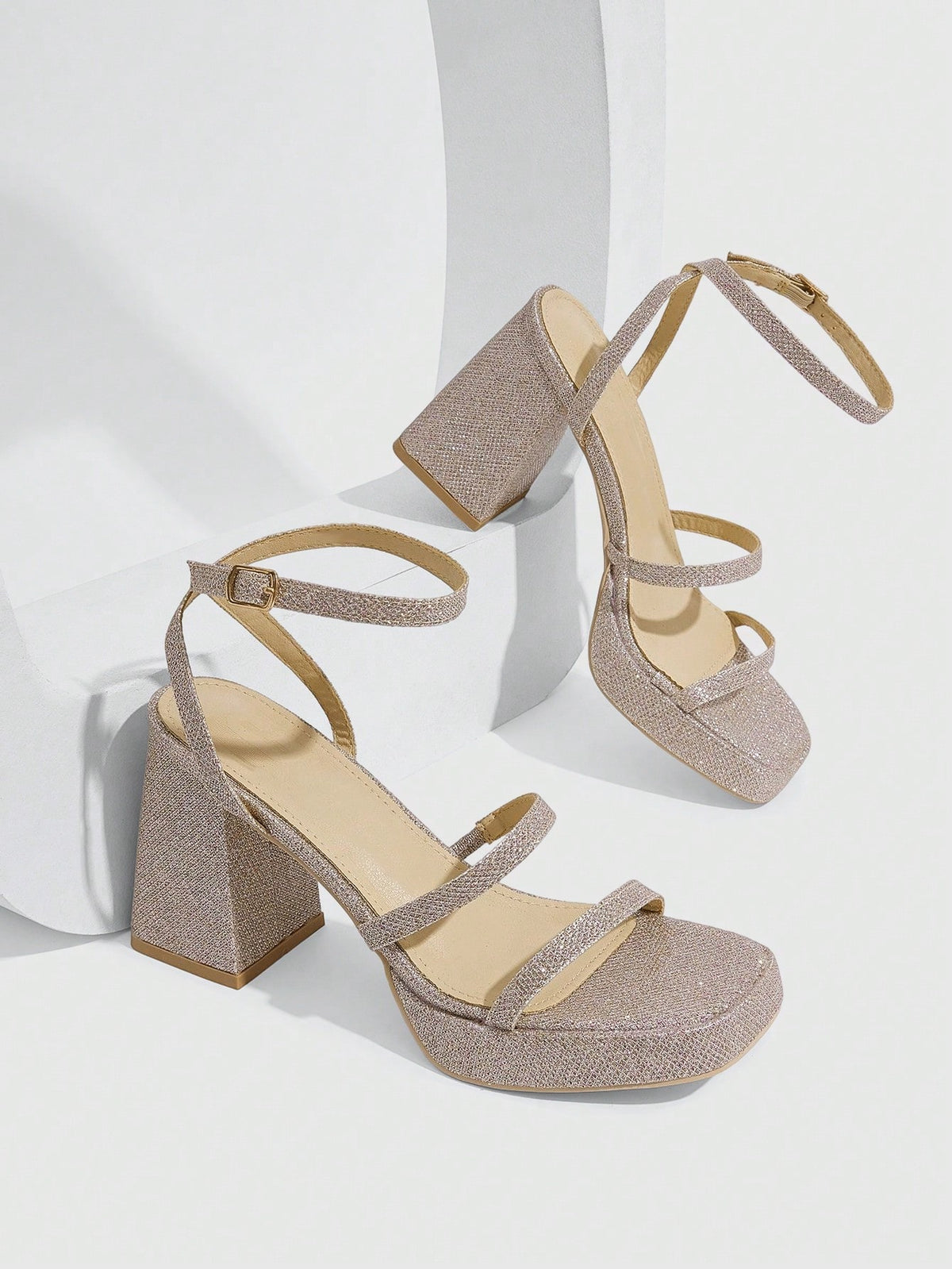 Women's high-heeled sandals with textured pattern, open toe design, chunky heel, and adjustable ankle buckle strap.