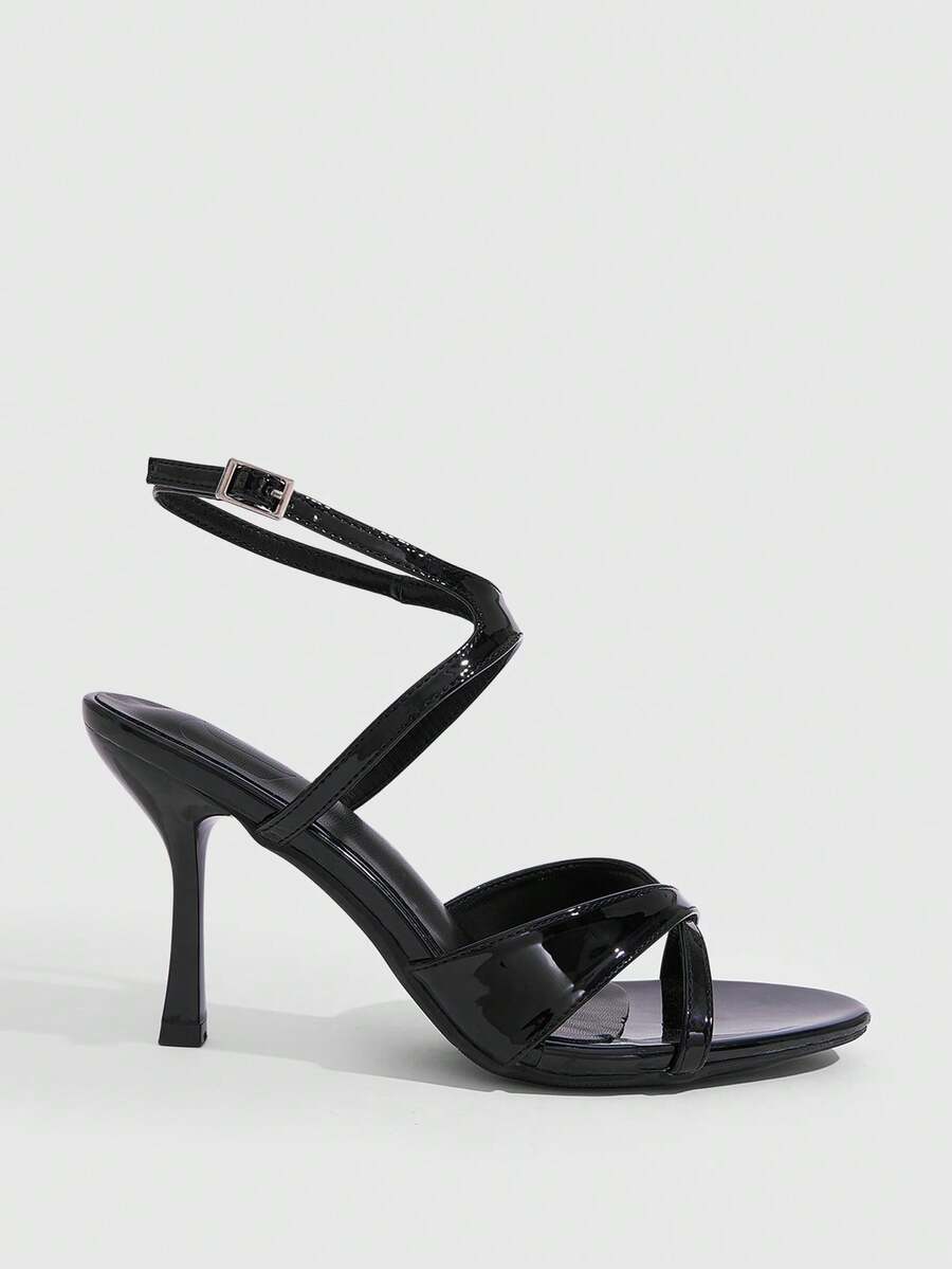 Women's glossy patent leather stiletto sandals in burgundy with open toe design and buckle strap closure.