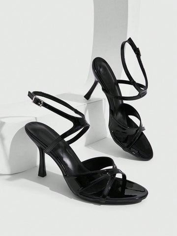 Women's glossy patent leather stiletto sandals in burgundy with open toe design and buckle strap closure.