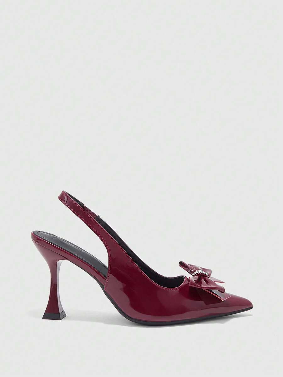 Women's pointed-toe high heel pumps in black mirror PU leather with an ankle strap, stiletto heel, and rhinestone buckle.